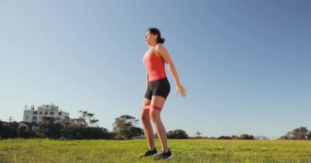 Eurasian Woman Does Squat Jumps Park Booty Band — Stock Video