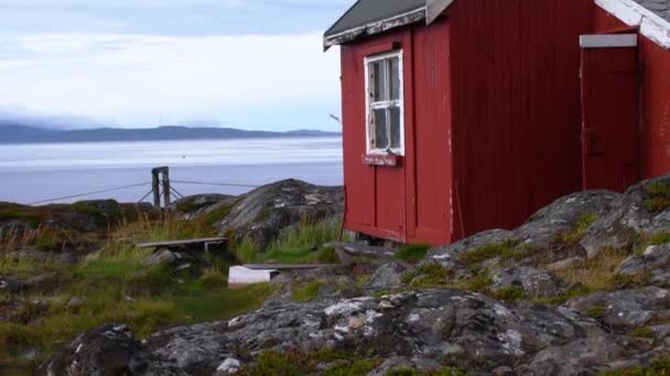 Traditional Norwegian Red Painted Tiny Wooden Hut Rocky Beach Tilt — Stock Video
