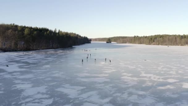 Aerial Drone Shot Group People Ice Skating Large Frozen Lake — Stock Video