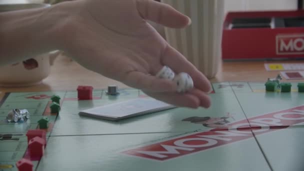 Close View Person Throwing Dice Game Monopoly Filmed Handheld — Stock video