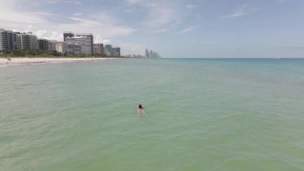 Aerial Spårar Ung Kvinna Bikini Som Simmar Ensam Surfside Miami — Stockvideo