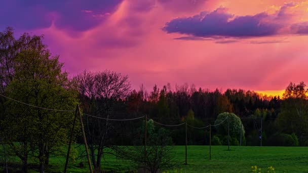 緑豊かな自然景観の上を高速で移動する雲と燃えるような夕日の時間経過 — ストック動画