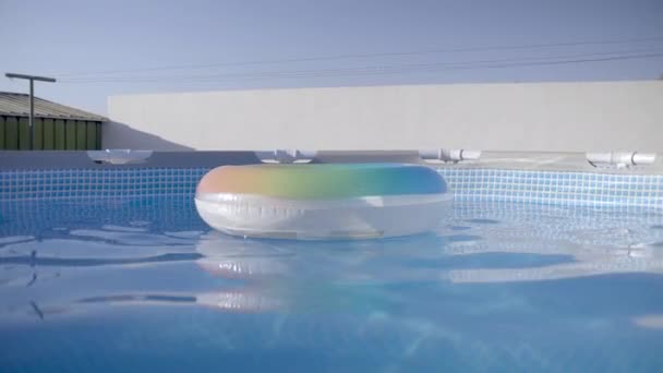 在水里的游泳池周围漂浮着五彩斑斓的甜甜圈 — 图库视频影像