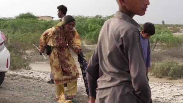 Child Helping Grandma Carrying Flood Relief Package Balochistan Road Slow — Stock Video