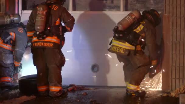 Bomberos Irrumpiendo Garaje Con Herramientas Adecuadas Para Apagar Fuego — Vídeos de Stock