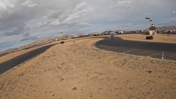 Apple Valley Speedwayレーストラックの周りのドリフト車を追いかけている最初の人スローモーションで — ストック動画