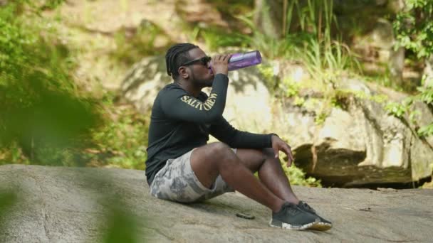 Hombre Toma Sorbo Agua Una Botella Una Roca Gigante Medio — Vídeos de Stock