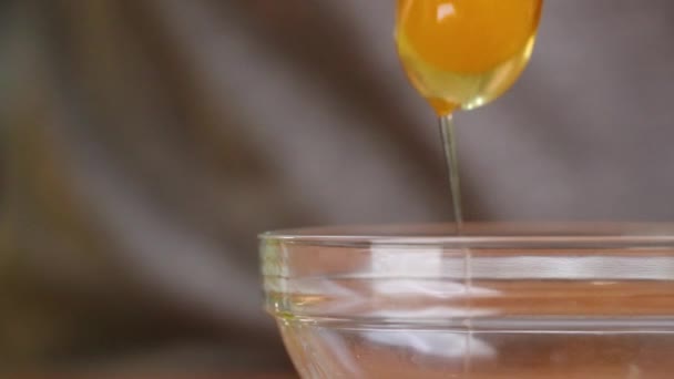 Bright Yellow Egg Yolk Drops Glass Mixing Bowl Slow Motion — Stock Video