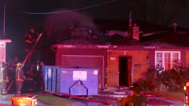 Firemen Climbing Roof House Extinguish Remaining Flames — Stock Video