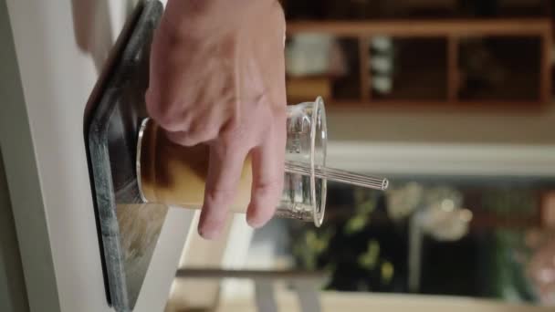 Vertical Video Hand Grabbing Refreshing Iced Latte Kitchen Counter Slow — Stock Video