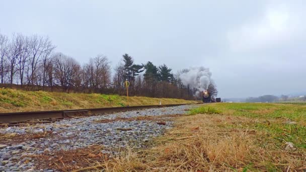 Low Angle View Antique Steam Passenger Train Approaching Blowing Steam — Stock Video