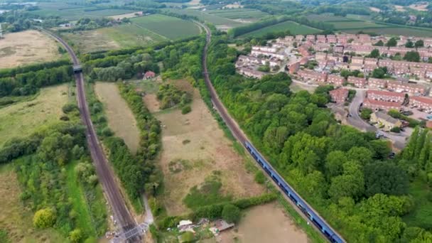 Arial Shot Train Going Passed Houses Heading Away Canterbury Dual — Stock Video