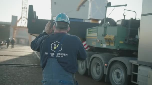 Äldre Man Ginving Instruktioner Hamnen Medan Lastbilen Transporterar Ett Nybyggt — Stockvideo