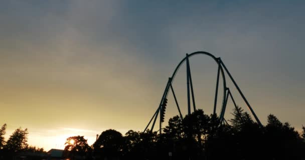 Slow Motion Roller Coaster Thrill Ride Sunset Backlit Sky Silhouette — Stok video