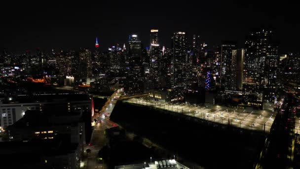 从皇后区长岛市俯瞰纽约的夜景 摄像机慢吞吞地进进进出出 慢慢地朝远处的火车站和帝国大厦飞去 — 图库视频影像