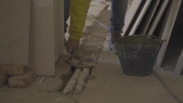 Construction Worker Spreads Cement Pipes Trowel — Stock Video