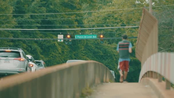 男は車でロードされた橋を渡って歩く — ストック動画