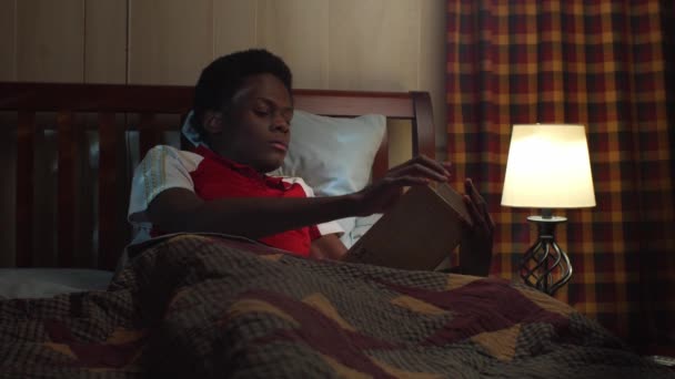 Ohnmächtiger Junger Schwarzer Mann Liest Bett Bevor Nachts Schläft — Stockvideo