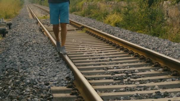 在一个可能被遗弃的车站 一个人的脚步声在铁轨上保持平衡的细节 就像他小时候那样 — 图库视频影像
