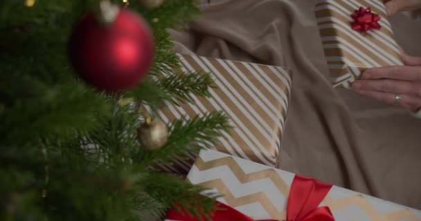 Female Hands Putting Present Christmas Tree Gimbal Circling High Angle — Stock Video