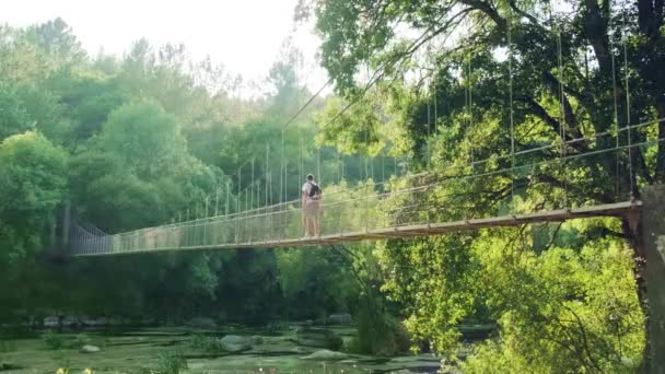 Establishing Shot Caucasian Man Crossing Rope Suspended Bridge Idyllic Forested — Stock Video
