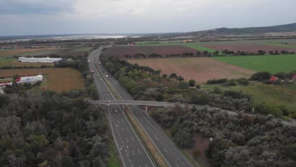 Aerial Drone Orbit Showing Busy Hungarian Highway Beautiful Lake Background — 비디오