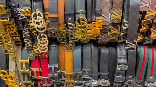 High quality fake designer belts hanging, Stock Video