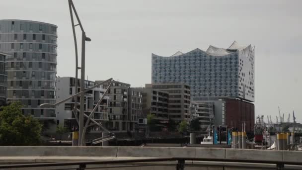 ハンブルクのエルプフィルハーモニーのSandtorkaiからの眺め夏の忙しい一日に新しい建物の不動産とプロムナードの人々に囲まれたハフエンティ — ストック動画