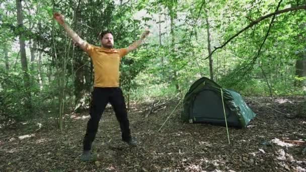 Slow Motion Man Doing Jumping Jacks Forest Campsite Front View — Stock Video
