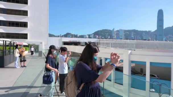 在阳光明媚的日子里 人们在港湾为香港岛的天际线拍照 享受下午的乐趣 — 图库视频影像