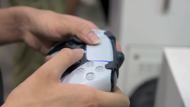 Gamer Plays Videogame Using Controller Japanese Video Gaming Brand Owned — Stock Video