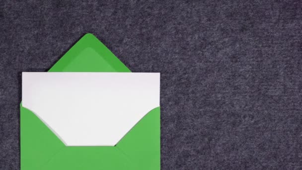 Ein Grüner Briefumschlag Mit Weißem Papier Betritt Die Szene Und — Stockvideo