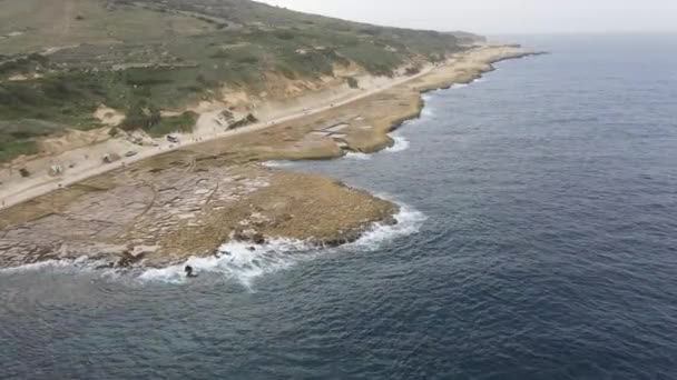 マルタのゴゾ島の塩パンと美しい地中海沿岸上空を飛行する空中ドローンショット 塩鍋に太陽の反射 — ストック動画