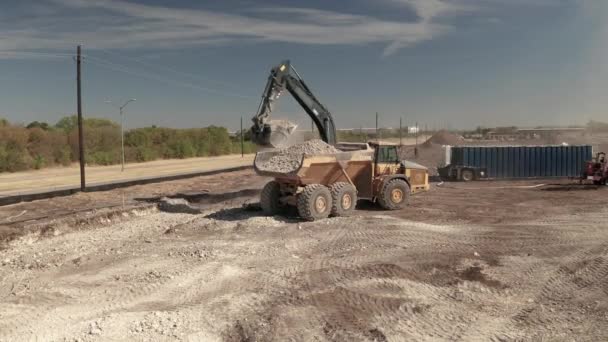 Construction Site Loader Picks Dirt Rocks Swings Them Dump Truck — Video