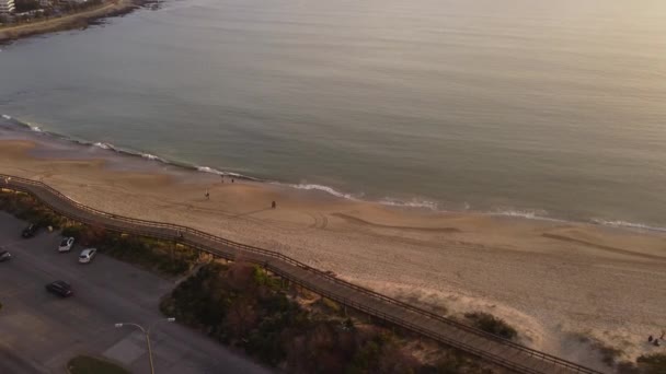 Folk Går Vid Solnedgången Längs Punta Del Este Stranden Med — Stockvideo