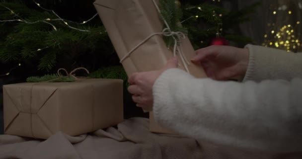Person Hands Put Wrapped Gift Vintage Paper Christmas Tree — Stock Video