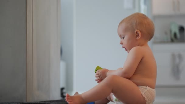 Profile Shot Cute Caucasian Toddler Baby Diaper Sitting Floor Playing — Stock Video