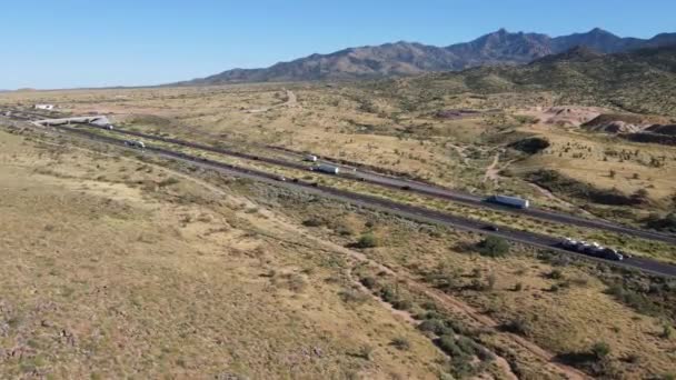 Aerial View Semis Cars Driving Highway Desert Mountains Background — Stock Video