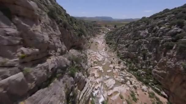 Fpv Drone Flies Close Rugged Rock Wall Narrow River Canyon — Stock Video