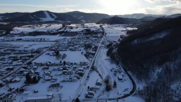 Snow Covered Town Village Mountain Valley Drone Pullback View — Stock Video