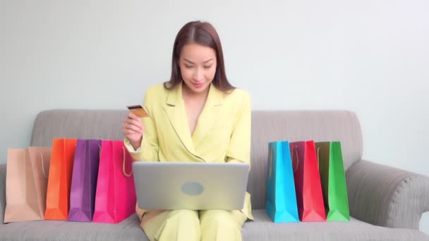 Young Businesswoman Sits Colorful Shopping Bags She Holds Credit Card — Stock Video