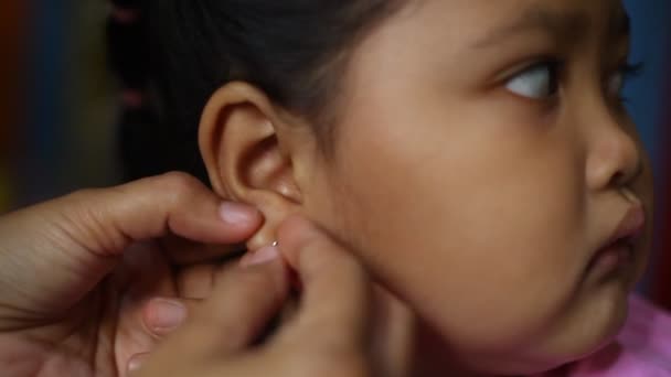 Close Aziatische Mam Hand Earings Naar Haar Dochter — Stockvideo