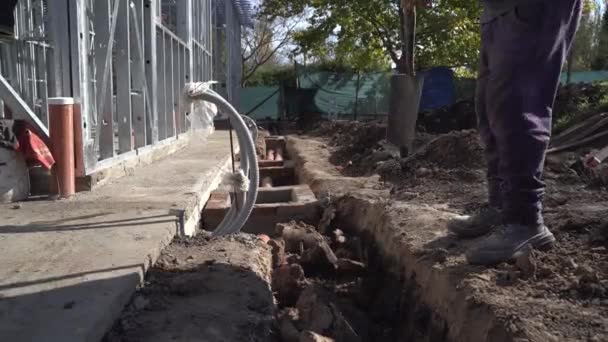 Man Digging Canal Shovel Next House Construction — Stock Video