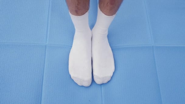 Man Stretching Fails Touch His Toes Blue Yoga Mat — Stock Video