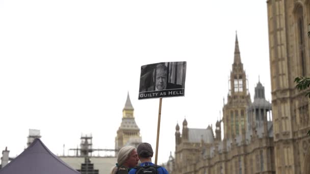Parlamentonun Dışındaki Parmaklıkların Arkasında Boris Johnson Fotoğrafı Olan Protestolu Pankart — Stok video