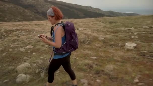 Shot Woman Hiking Top Mountain Range Watching Her Smartphone Instead — Stock Video