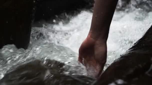 Person Puts Hand Fast Flowing Stream Water Passes Rocks — Stock Video