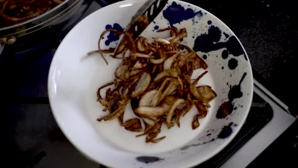 Golden Brown Crispy Fired Sliced Onions Being Placed Plate Overhead — Stock Video