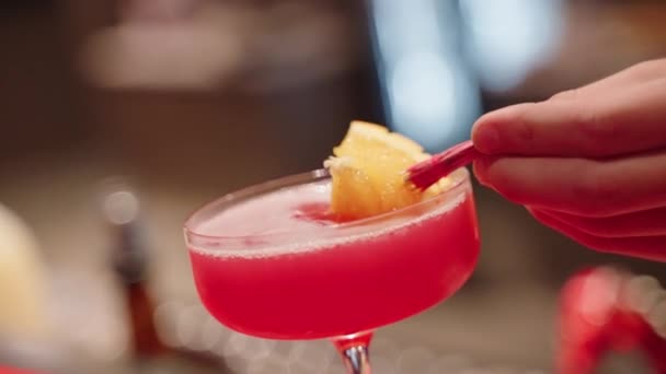 Slow Motion Bartender Placing Decoration Orange Fruit Umbrella Red Cocktail — Stock Video