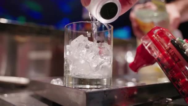 Slow Motion Bartender Hand Pouring Shot Glass Gin Glass Ice — Stock Video